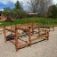 Outdoor wooden playground structure with climbing and exercise elements for children and adults.