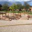 Wooden outdoor playground equipment 'Course' with various climbing structures and ropes.