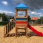 Logo Tower with Climbing Net playhouse with slide in playground setting