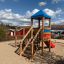 Playground structure with slide and climbing net, Logo Tower with Climbing Net playhouse.