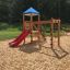 Playground with Logo Tower playhouse, climbing net, and slide.
