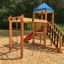 Wooden playhouse with climbing net and slide in a park
