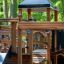 Wooden playground equipment of Gigantic castle with slide in park.