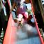 Child sliding down on Activity Center slide.