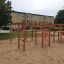 Playground Activity Center with Slide in a sandy area.