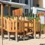 Rubik Modern Nature wooden playhouse with slide in a playground setting.