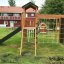 Modern Nature wooden playhouse with slide and climbing net.