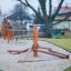 Atakama wooden playground climbing structure on sand surface