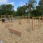 Horizontal Wooden Ladder Nature on a children's playground surrounded by wood chips.
