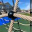 Close-up of the V-shape Net wooden playhouse with ropes and climbing net.