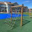 V-shape Net wooden playhouse in an outdoor playground.