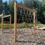 V-shape Net wooden playhouse in an outdoor playground.