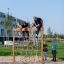 Children playing on a V-shape Net wooden playhouse.