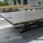 Spring Plate by Lars Laj in a parking lot with a special design structure.