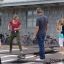 People enjoying the Spring Plate outdoor play equipment in an urban setting.