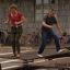 Spring Plate - adults engaging in balance and coordination exercise on outdoor playground equipment.