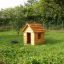 Wooden Nature Playhouse in a grassy garden.
