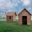 Nature Playhouse outdoor wooden playhouses with swings in the background.