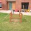 Trapezoidal wooden climbing structure for children in a backyard
