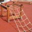 Trapezoidal wooden playground climbing structure with rope nets.
