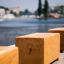 Wooden bench Cube by a riverside.