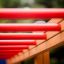 Horizontal Ladder wooden ladder with red rungs in a playground.