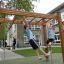 Children playing on Horizontal Ladder wooden ladder in a school playground.