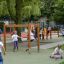 Children playing on Horizontal Ladder wooden ladder in a playground