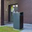 Modern Oxford bin outside brick building.
