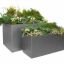 Two gray rectangular Chicago Flowerpots filled with various green plants.