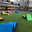 Colorful Lounge Sofa outdoor furniture on green grass in a schoolyard.