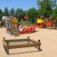 Children playing on the Honeycomb playground structure with colorful towers and slides.