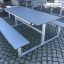 Outdoor Table & Bench HPL set on a cobblestone surface.