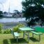 Table & Bench HPL in a park overlooking a riverside landscape.