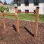 Outdoor playground equipment Somersault Double with two red horizontal bars.