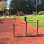 Somersault Double playground equipment with a wooden frame on a safety rubber surface.