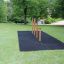 Outdoor Somersault Triple gym equipment on a grassy area with safety mats.