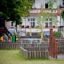 Playground equipment Somersault Triple with wooden barriers and metal bars.