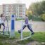 Outdoor fitness equipment - Cross Trainer, in use by two young women in a park.