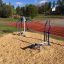 Outdoor Cross Trainer at a park near a running track.
