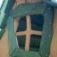 A wooden window frame of Nill's Playhouse children's playhouse.