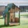 Nill's Playhouse wooden play structure for children on a grassy playground