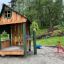 Nill's Playhouse outdoor wooden play structure for children in a park setting.