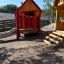 Olle's Playhouse wooden playhouse with slide in playground'