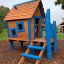Olle's Playhouse wooden play structure with blue accents in a playground.