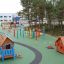 Olle's Playhouse on a colorful and engaging playground in an outdoor setting.