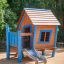 Olle's Playhouse wooden play house with blue accents and slide in a playground