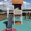 Lisa's Playhouse with slide on an outdoor playground.