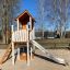 Lisa's Playhouse with slide in a playground setting